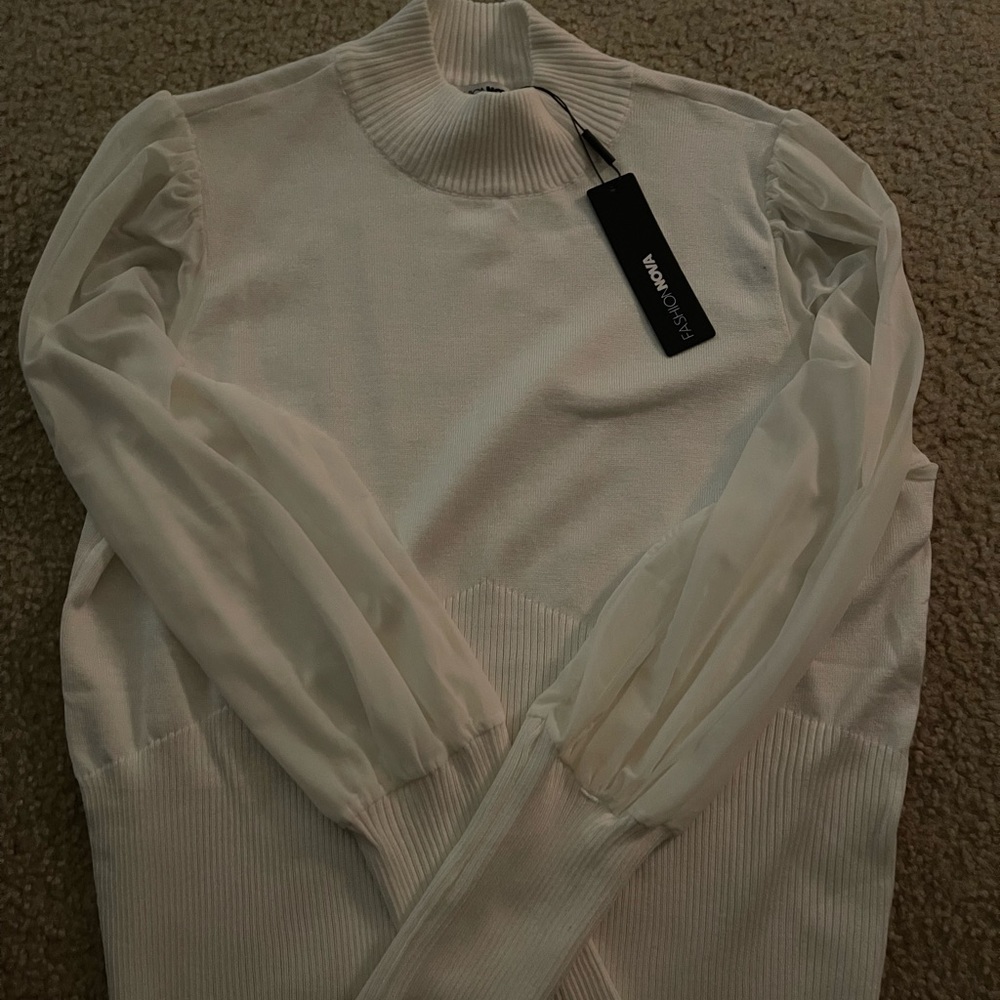 A tan long sleeve turtle neck shirt.